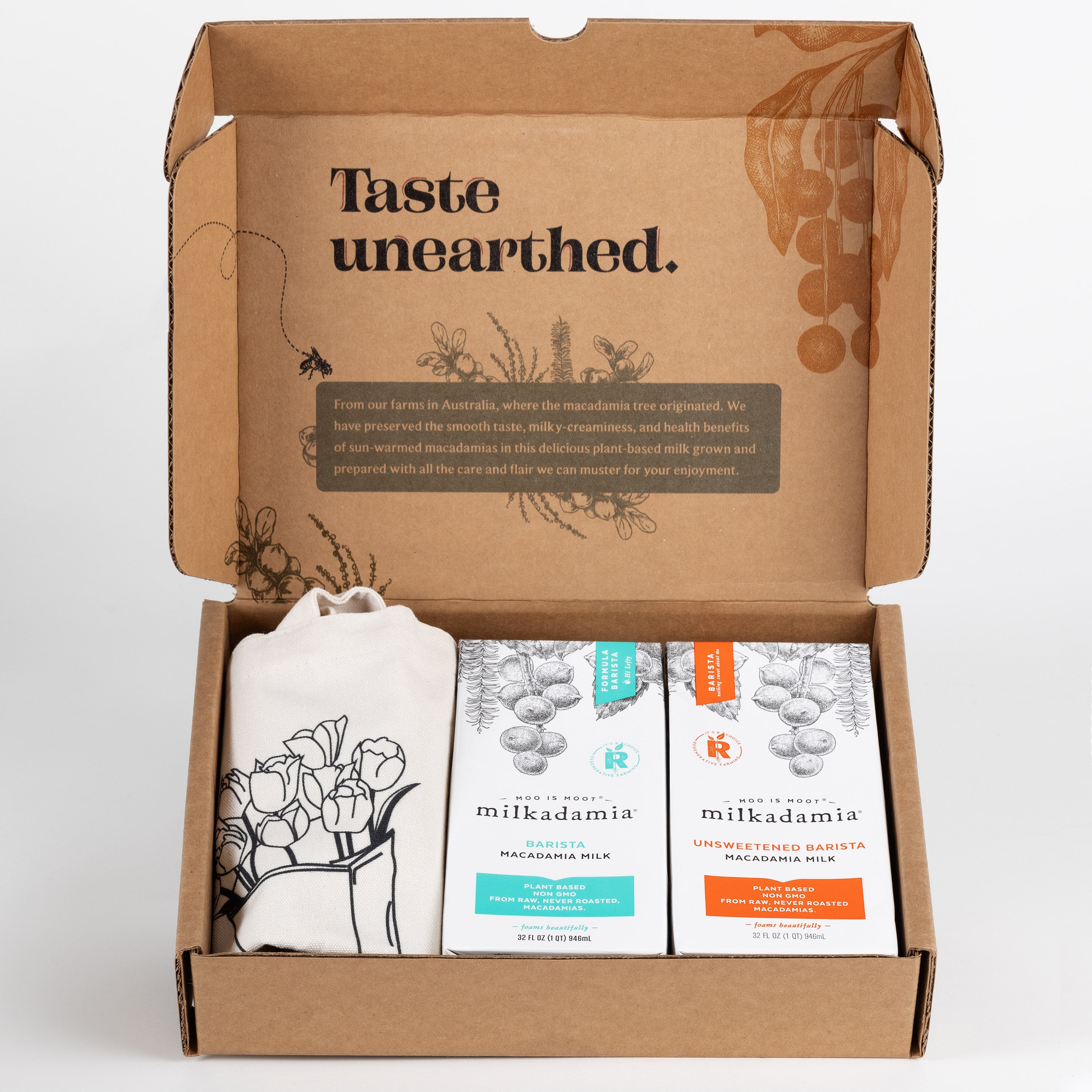 Milkadamia Barista Blend holiday gift box containing two individual 32 oz cartons of  Milkadamia Barista and Unsweetened Barista and a signature Milkadamia tote bag