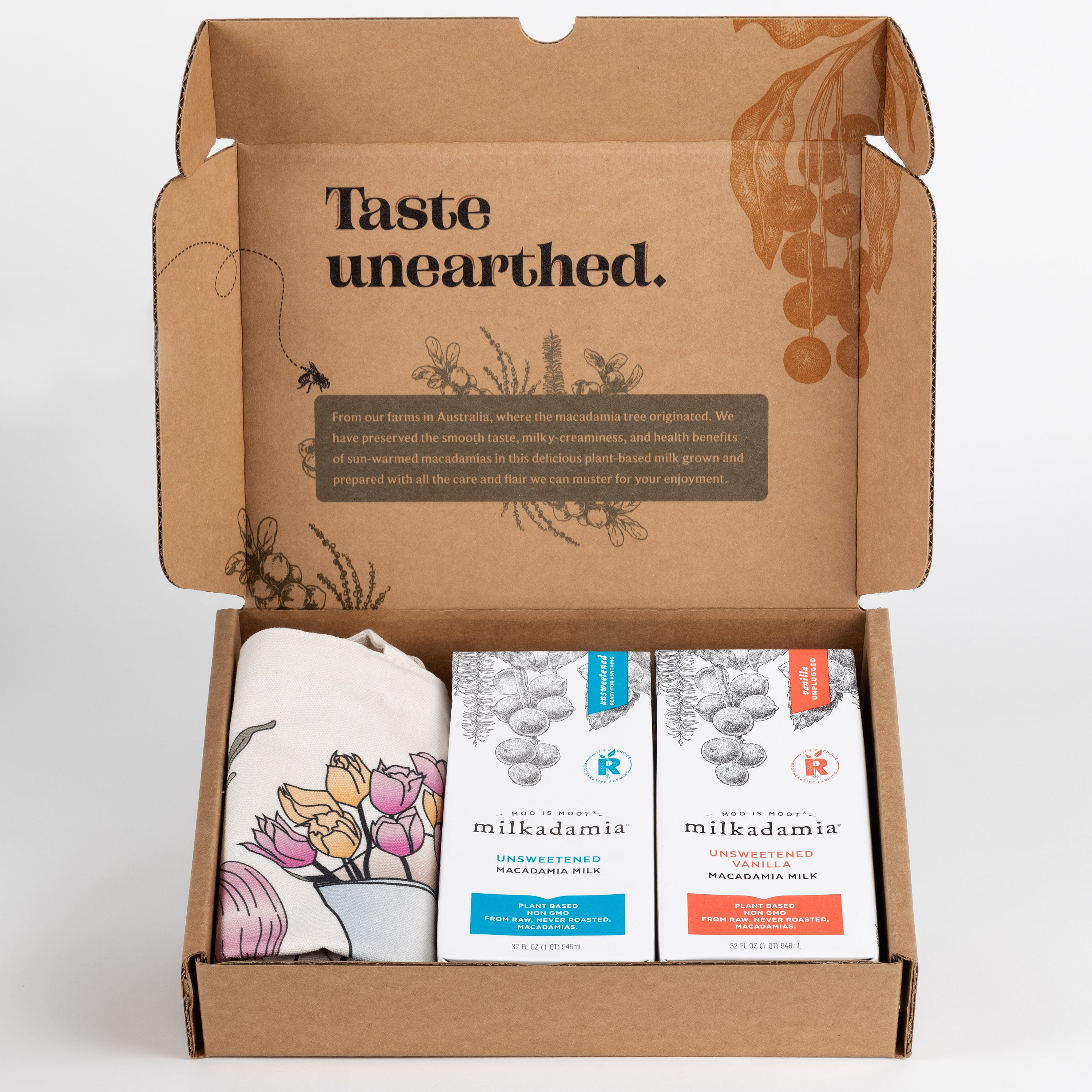 Milkadamia unsweet holiday gift box containing two individual 32 oz cartons of  Milkadamia Unsweetened and Unsweetened Vanilla and a signature Milkadamia tote bag