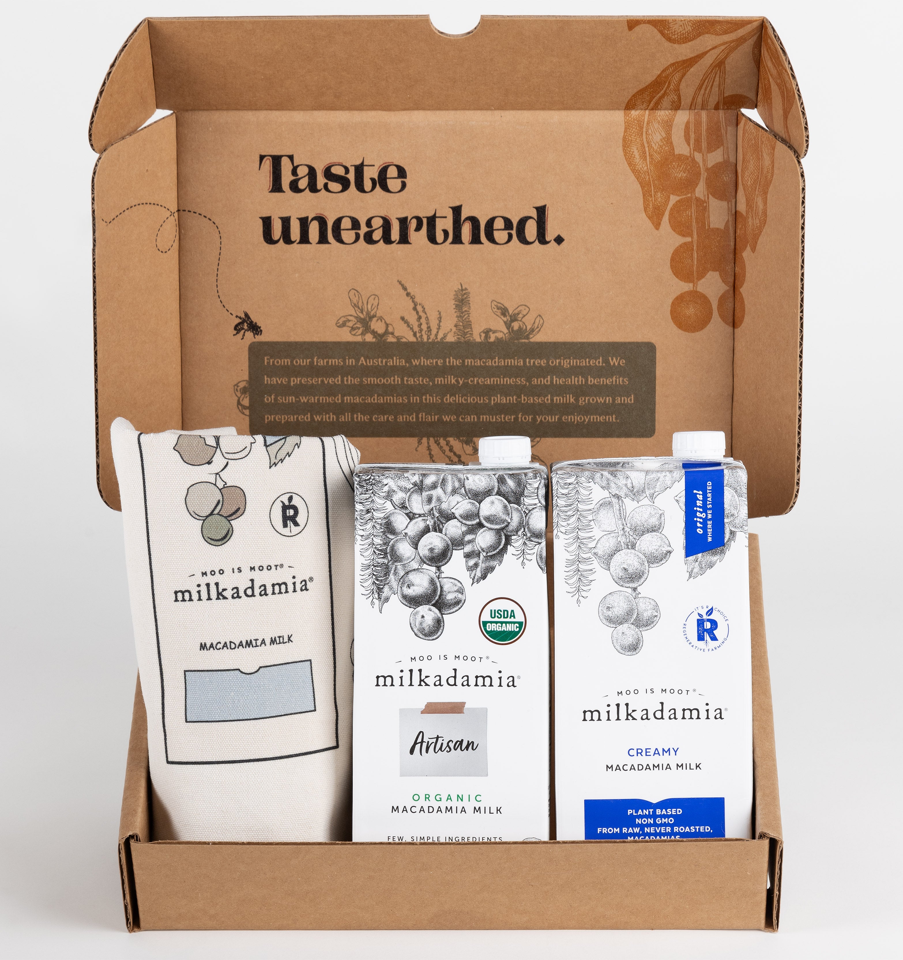 Milkadamia sweet holiday gift box containing two individual 32 oz cartons of  Milkadamia Creamy and Organic Artisan and a signature Milkadamia tote bag