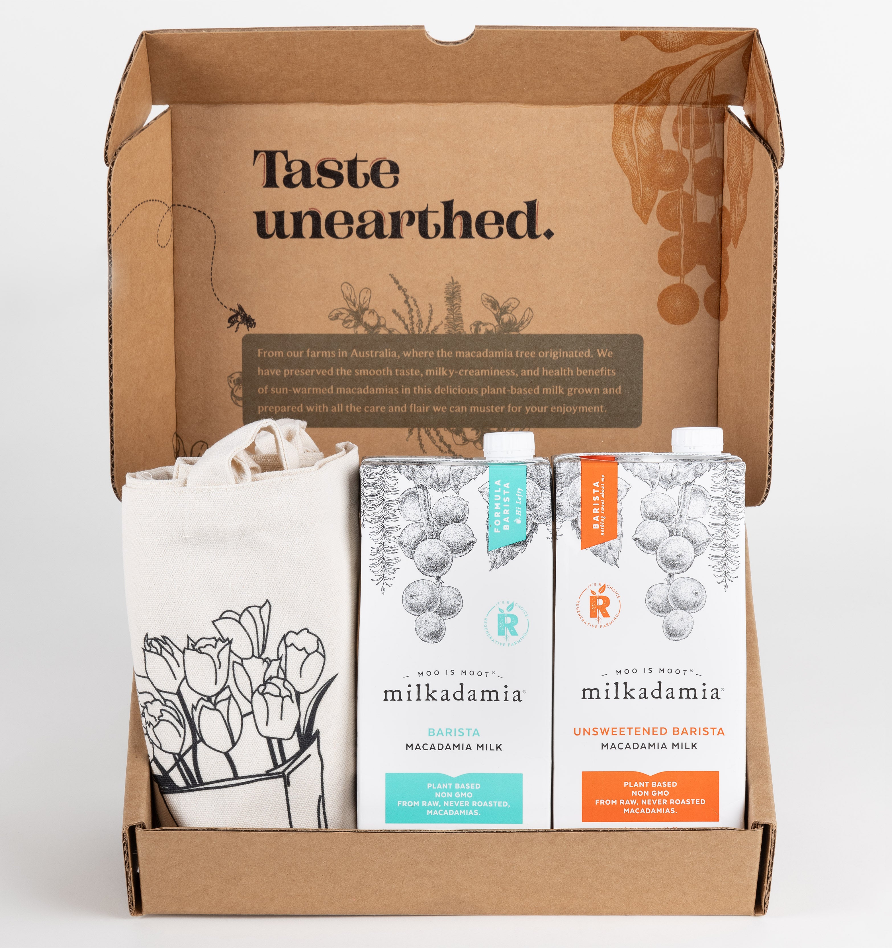 Milkadamia Barista Blend holiday gift box containing two individual 32 oz cartons of  Milkadamia Barista and Unsweetened Barista and a signature Milkadamia tote bag