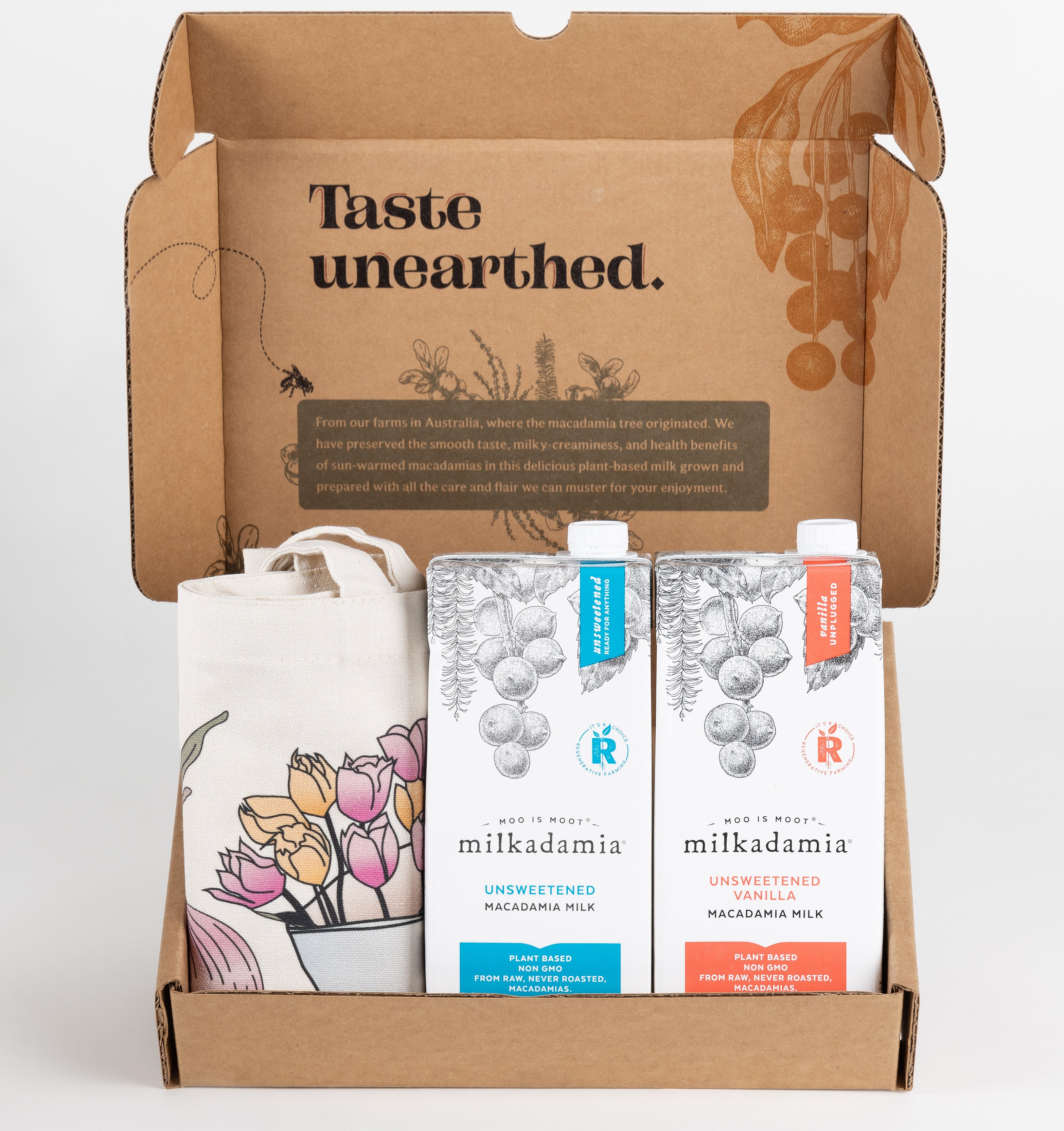 Milkadamia unsweet holiday gift box containing two individual 32 oz cartons of  Milkadamia Unsweetened and Unsweetened Vanilla and a signature Milkadamia tote bag